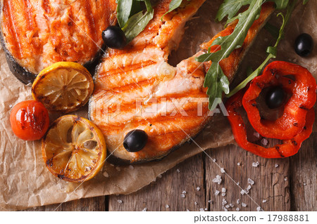 圖庫照片: grilled salmon steak on paper. horizontal top view