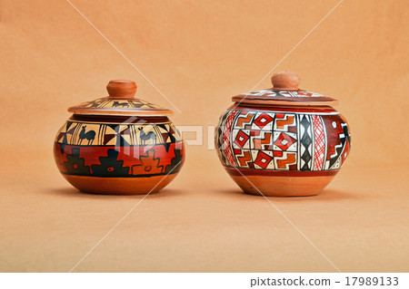 Two painted ceramic pot with lids on kraft paper 17989133