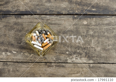 ashtray full of butt cigarettes on wooden  17991110