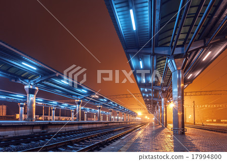 Railway station at night. Train platform in fog 17994800