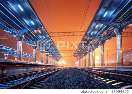 Railway station at night. Train platform in fog 17994805