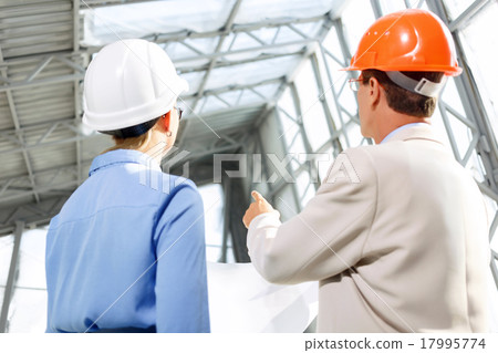 Professional architects discussing project Professional architects discussing project 17995774