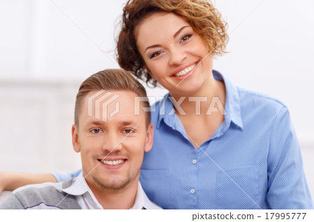 Pleasant couple sitting in the armchair  17995777