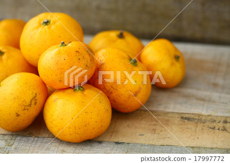Fresh orange on wooden table in dining room. Fresh orange on wooden table in dining room. 17997772