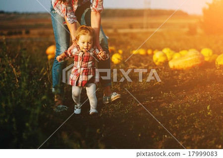 mother teaching her daughter to walk 17999083