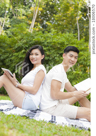 An Asian young couple dating in a park. An Asian young couple dating in a park. 18006570