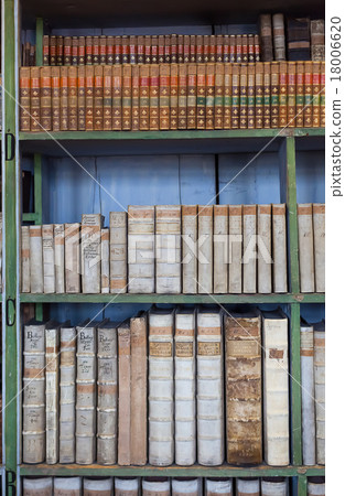 historic old books in library, wooden bookshelf 18006620