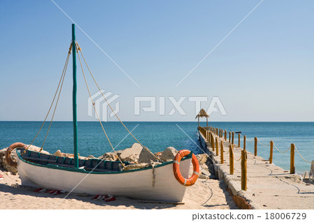 Boat on the beach at sunrise time Boat on the beach at sunrise time 18006729