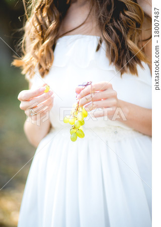 Beautiful young woman with grape bunches against Beautiful young woman with grape bunches against 18007487