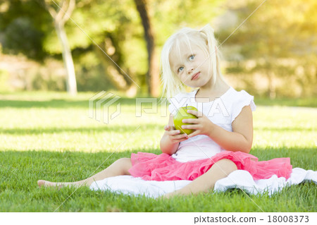 Little Girl In Grass Eating Healthy Apple Little Girl In Grass Eating Healthy Apple 18008373