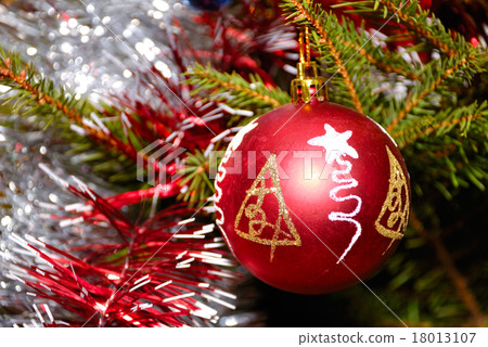 Red xmas ball hanging on fir tree 18013107