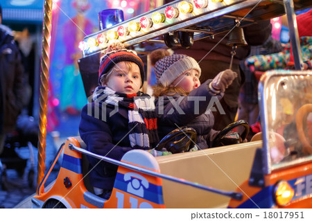 Little boy and girl on a carousel at Christmas market 18017951