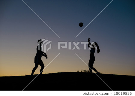 Boy and girl playing volleyball on the weekend. Boy and girl playing volleyball on the weekend. 18019836