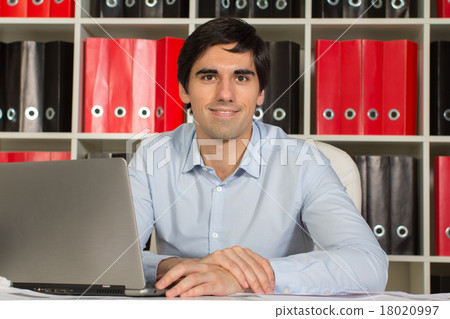 Office manager working on laptop 18020997