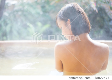 A woman entering a hot spring 18022375