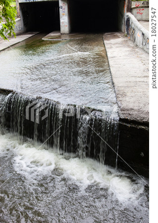 Water stream flowing out the underground tunnel Water stream flowing out the underground tunnel 18027547