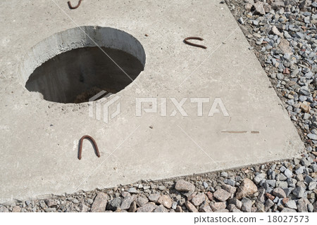 Manhole without cover in new concrete block 18027573