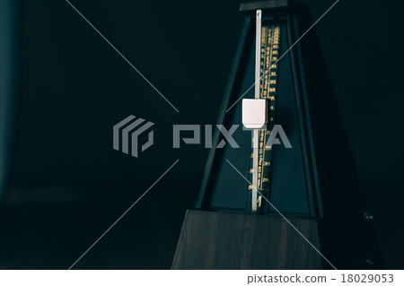 Vintage metronome, on a dark background. Vintage metronome, on a dark background. 18029053