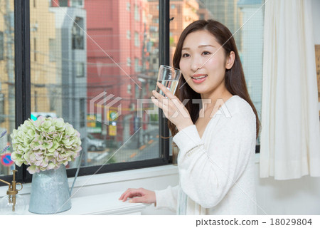 A woman drinking water A woman drinking water 18029804