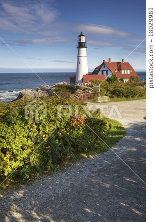 A vertical view of Portland Light in Maine on a be 18029981