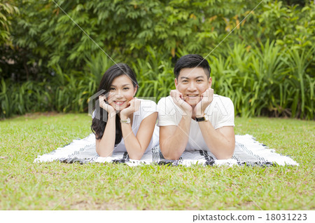 A young Asian couple enjoying a day in a park. 18031223