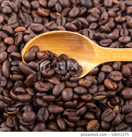 Coffee beans and wooden spoon on white background. Coffee beans and wooden spoon on white background. 18031275