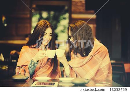 Two young and beautiful girls gossiping 18032769