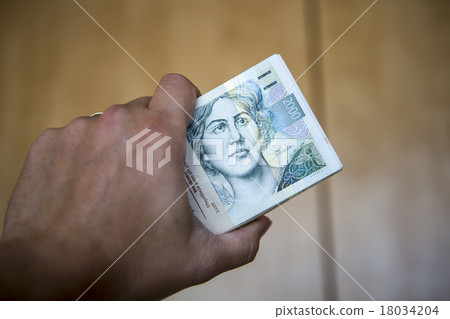 pack of money - big pile of banknotes in hand 18034204