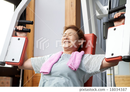Middle aged women exercising at the gym Middle aged women exercising at the gym 18034387