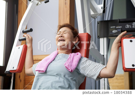 Middle aged women exercising at the gym Middle aged women exercising at the gym 18034388