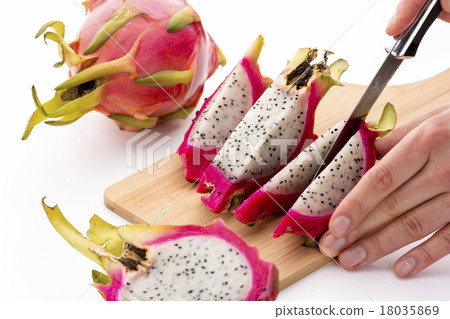Cutting A Halved Pitaya Into Four Fruit Wedges 18035869