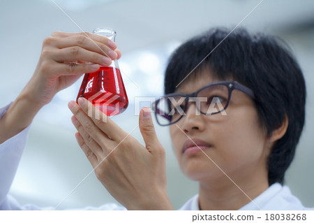 Researcher working with chemical Researcher working with chemical 18038268