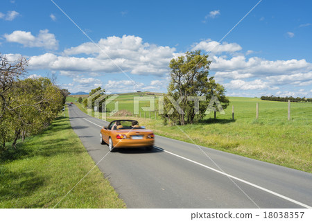 Car travelling on country road 18038357