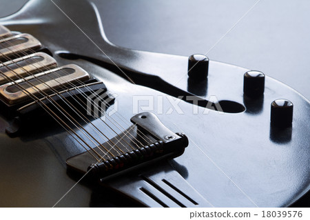 Black electric guitar lying on the table Black electric guitar lying on the table 18039576