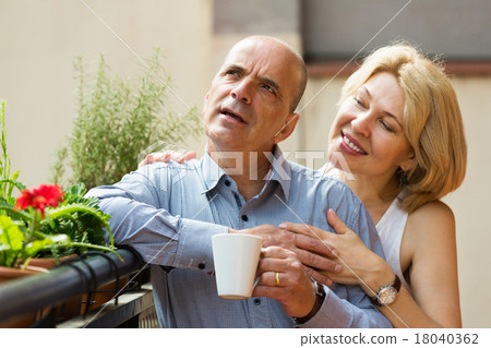 Mature couple on balcony with coffee Mature couple on balcony with coffee 18040362