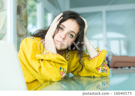 Girl sitting along at the table 18040575