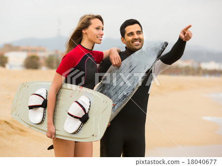 Couple with surf boards on the beach . 18040677