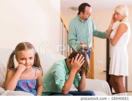 Children in silence while parents arguing 18040681