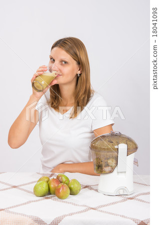 Girl drinks freshly pear juice Girl drinks freshly pear juice 18041098