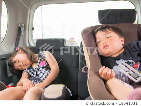 Child asleep by car Child asleep by car 18041331