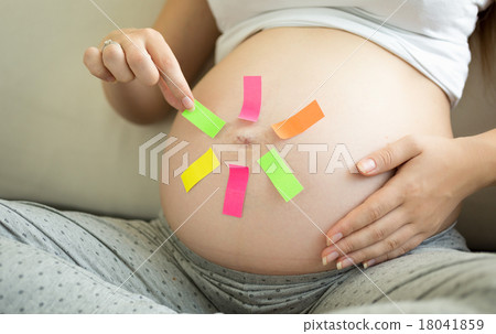 pregnant woman making choice on colorful stickers 18041859