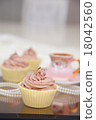 Three chocolate cup cakes in a row 18042560