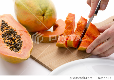 Half A Papaya Fruit Being Cut Into Slices 18043627