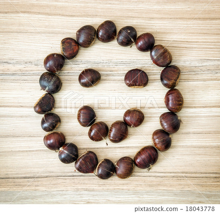 Chestnut smiley on the wooden plate 18043778