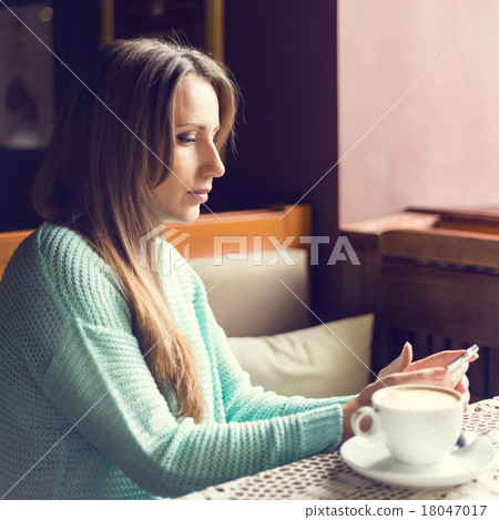 Photo of a beautiful happy young woman with smartphone 18047017