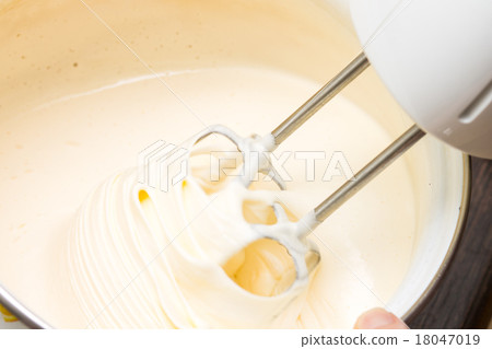 Whisking liquid batter by electric mixer Whisking liquid batter by electric mixer 18047019