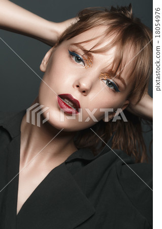 Stock Photo: Sexy blonde girl with red lips, gold on the eyes