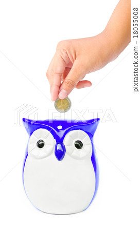 hand putting coin into a owl bank hand putting coin into a owl bank 18055008