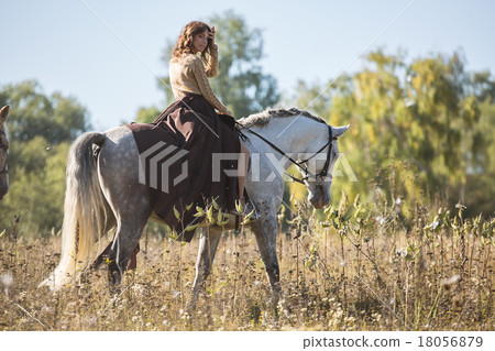 Beautiful girl riding a white horse 18056879