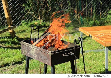 Fire burns in the grill Fire burns in the grill 18062826